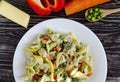 Pasta with vegetables and cheese on a white plate colored background top view Royalty Free Stock Photo