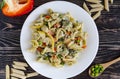 Pasta with vegetables and cheese on a white plate dark wooden background home cooking concept Royalty Free Stock Photo