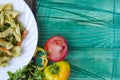 Pasta with vegetables and cheese in a white plate on a green background copy space Royalty Free Stock Photo