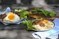 Pasta with vegetables grilled meat and baked egg yolk on dark wooden table Royalty Free Stock Photo