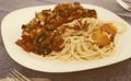 Pasta with vegetables grilled meat and two baked egg yolk on white plate Royalty Free Stock Photo