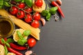 Pasta, vegetables, herbs and spices for Italian food on black background Royalty Free Stock Photo
