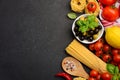 Pasta, vegetables, herbs and spices for Italian food on black background Royalty Free Stock Photo