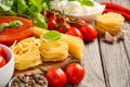 Pasta, vegetables, herbs and spices for Italian food on rustic wooden table Royalty Free Stock Photo