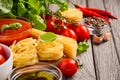 Pasta, vegetables, herbs and spices for Italian food on the rustic wooden table Royalty Free Stock Photo