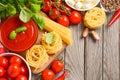 Pasta, vegetables, herbs and spices for Italian food on the rustic wooden table Royalty Free Stock Photo