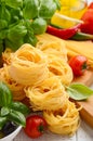 Pasta, vegetables, herbs and spices for Italian food on white wooden background Royalty Free Stock Photo