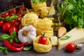 Pasta, vegetables, herbs and spices for Italian food on the wooden background Royalty Free Stock Photo