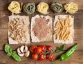 Pasta, vegetables and herbs on wood Royalty Free Stock Photo