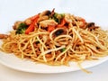 Pasta with vegetables, mushrooms and chicken . Chinese pasta,fried soba noodles with mushrooms, carrots, peppers closeup on white Royalty Free Stock Photo