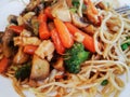 Pasta with vegetables, mushrooms and chicken . Chinese pasta,fried soba noodles with mushrooms, carrots, peppers closeup on white Royalty Free Stock Photo