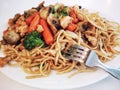 Pasta with vegetables, mushrooms and chicken . Chinese pasta,fried soba noodles with mushrooms, carrots, peppers closeup on white Royalty Free Stock Photo