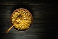 Pasta in a vintage plate and wooden spoon. Low key cooking concept for breakfast on vintage dark table Royalty Free Stock Photo