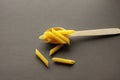 pasta in a wooden spoon on a dark Royalty Free Stock Photo