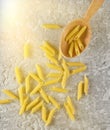 Pasta in a wooden spoon on a gray concrete table Royalty Free Stock Photo