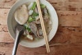 Paste of rice flour with spoon and chopsticks in the bowl isolated on wooden background closeup. Royalty Free Stock Photo