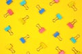 Pasted paper clip pattern, top view on a bright yellow background Royalty Free Stock Photo