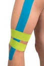 Pasted medical tape on injured leg, side view, isolated on white