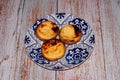 Pasteis De Nata, Pastel de Belem, traditional Portuguese miniature egg custard pastry cakes served on a dish