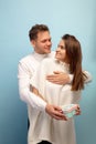 Beautiful couple in love on blue studio background. Valentine& x27;s Day, love and emotions concept Royalty Free Stock Photo