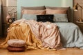 Pastel blue, pink and orange bedding on double bed in bedroom Royalty Free Stock Photo