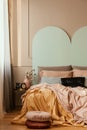 Pastel blue, pink and orange bedding on double bed in chic bedroom interior Royalty Free Stock Photo