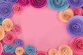 Pastel paper craft rose flat lay background with flowers around the endges and empty copy space in m