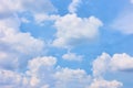 Pastel blue sky with white heap clouds