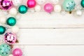 Pastel Christmas bauble corner border over white wood Royalty Free Stock Photo