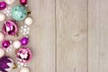 Pastel Christmas bauble side border on rustic white wood