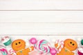 Pastel Christmas sweets decor, bottom border over white wood