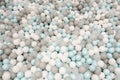 Pastel color white, grey, blue plastic balls background for baby activity. Kid's playing room interior. Copyspace