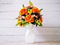 Pastel colored artificial flowers bouquet in pot on table, copy space for text or lettering pretty background or wallpaper Royalty Free Stock Photo