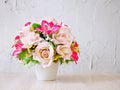 Pastel colored artificial rose flowers bouquet in pot on table, Royalty Free Stock Photo