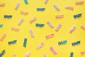 Pastel colored baby confetti on yellow background