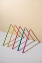 Pastel colored crayons in a 3d composition with shadows making triangle shapes Royalty Free Stock Photo