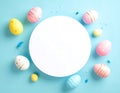 Pastel colored Easter eggs arranged in a circle around a blank white space on a light blue background with confetti Royalty Free Stock Photo