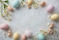 Pastel-colored Easter eggs with floral patterns, bunny figurines, and delicate white flowers arranged on a marble Royalty Free Stock Photo