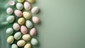 Pastel colored easter eggs with polka dots arranged on a light green fabric background studio shot Royalty Free Stock Photo