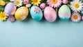 Pastel colored easter eggs and spring flowers on blue background.Top view, flat lay.Easter banner for design with copy space. Royalty Free Stock Photo