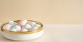 Pastel colored Easter eggs in white bowl on a table Royalty Free Stock Photo