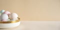 Pastel colored Easter eggs in white bowl on a table Royalty Free Stock Photo