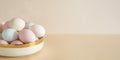 Pastel colored Easter eggs in white bowl on a table Royalty Free Stock Photo