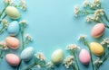 Pastel colored Easter eggs and white flowers arranged on a bright blue background. Objects lay flat creating a simple yet elegant Royalty Free Stock Photo