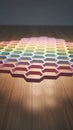 Pastel Colored Hexagonal Grid Pattern Laid Out on a Wooden Surface with Soft Spotlight Illumination Creating a Warm and Inviting Royalty Free Stock Photo