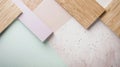 Pastel colored paper, wood and concrete samples are laying on a table, creating a visually appealing flat lay Royalty Free Stock Photo
