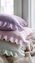 Pastel-colored ruffled pillows on cozy window seat with soft light Royalty Free Stock Photo