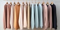 Pastel-colored sweatshirts hang on a hanger