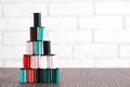 Pastel colored tailor thread bobbins stacked in pyramid form Royalty Free Stock Photo