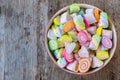 Pastel and colorfu of marshmallow and gummy candy in a wooden bowl on wooden background.